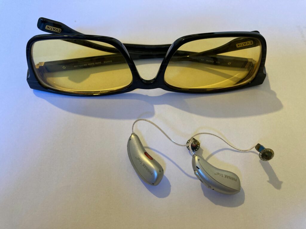 photo of Irlen spectral filters with yellow lenses and Phonak low-gain hearing aids